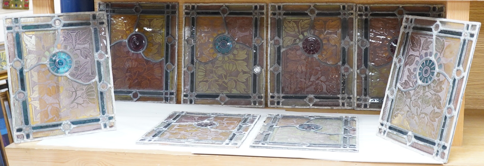 A set of eight late 19th century leaded stained glass panels, 23cm x 28cm
